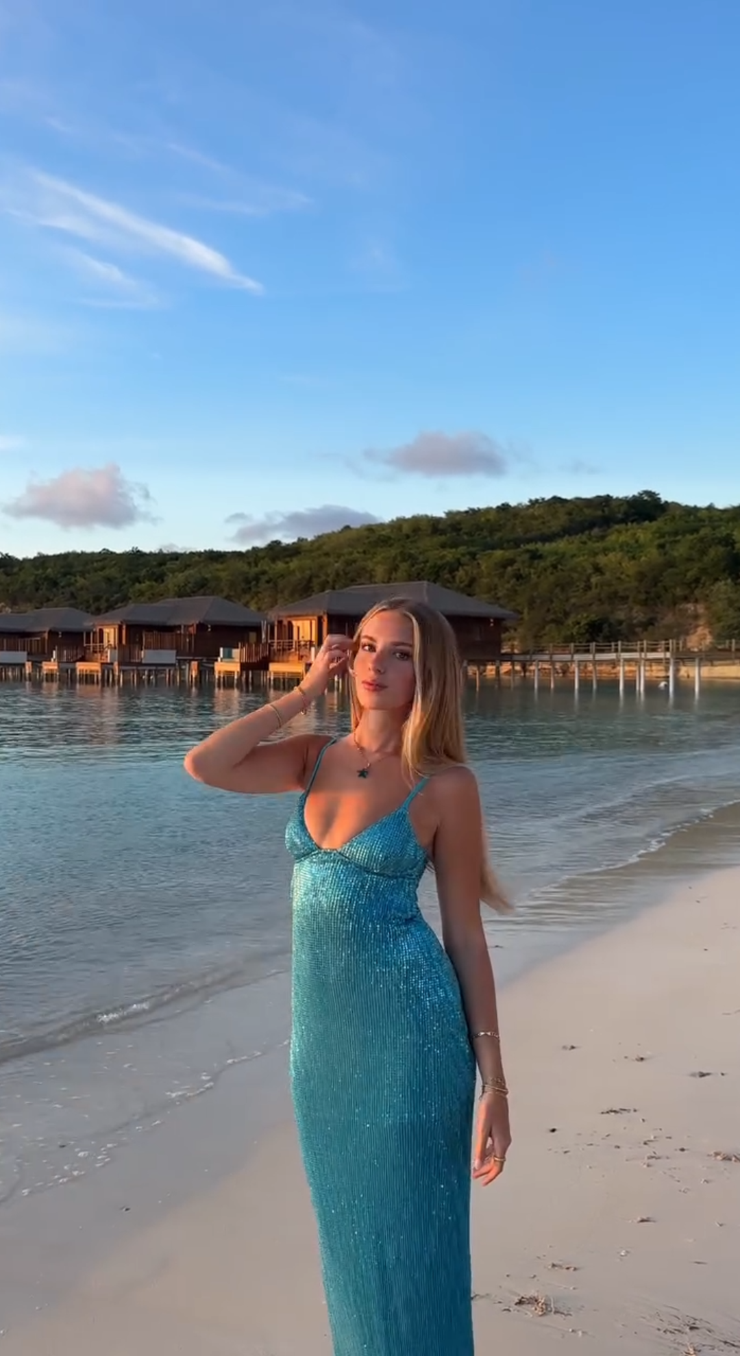 Nika in a blue dress on an Antigua beach